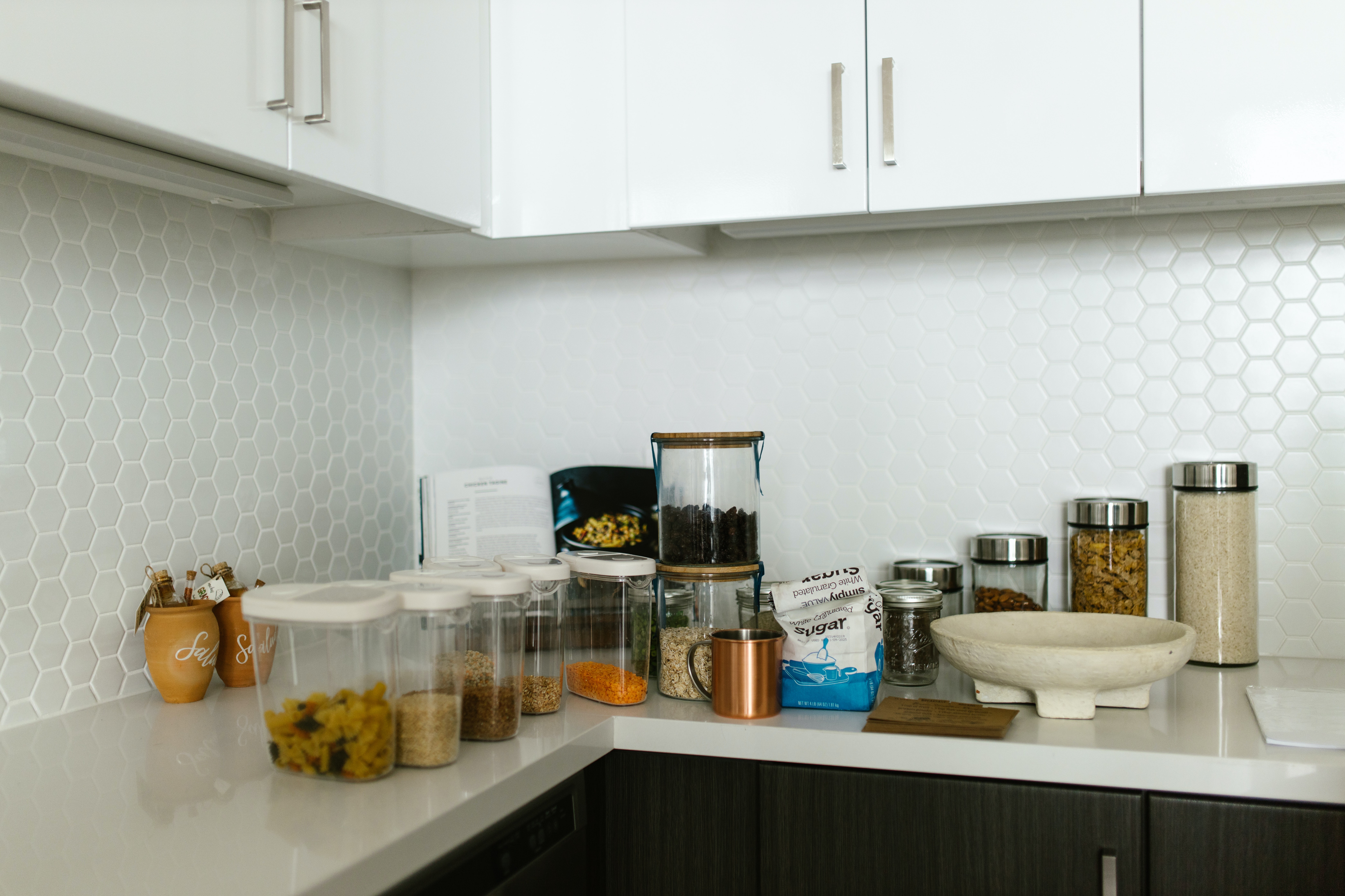 Clear Plastic Containers and Glass Jars on a Kitchen Counter